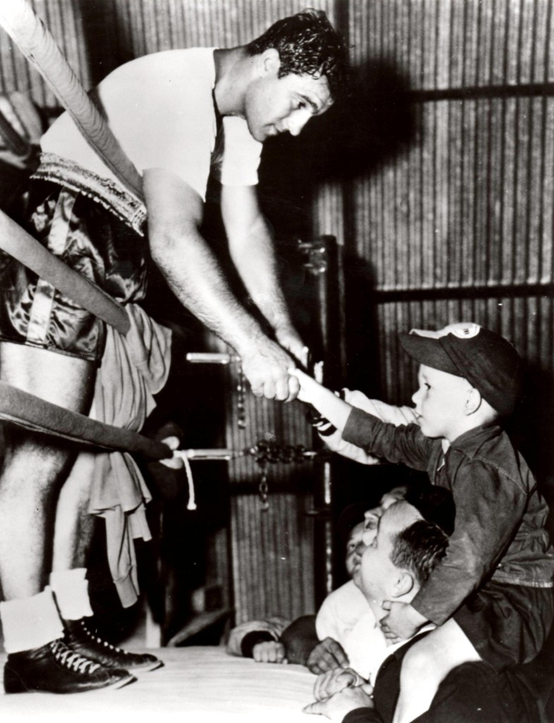 Rocky Marciano shaking hands with young fans