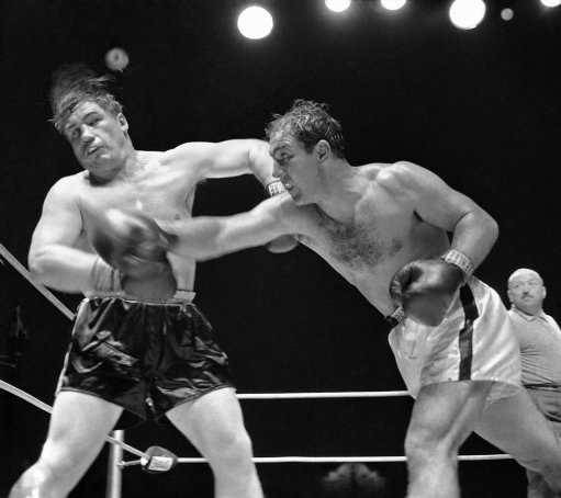 Rocky Marciano, heavyweight champion from Brockton, Mass., rocks challenger Don Cockell with a wicked right in the ninth round of their title bout at Kezar Stadium in San Francisco, Calif., May 16, 1955. Rocky kept his title via a TKO when the referee stopped the bout after 54 seconds of the ninth round. (AP Photo)