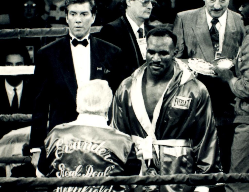 World heavyweight Champion Evander "The Real Deal" Holyfield with trainer Lou Duva and ring announcer Michael Buffer. *(PHOTO BY ALEX RINALDI)