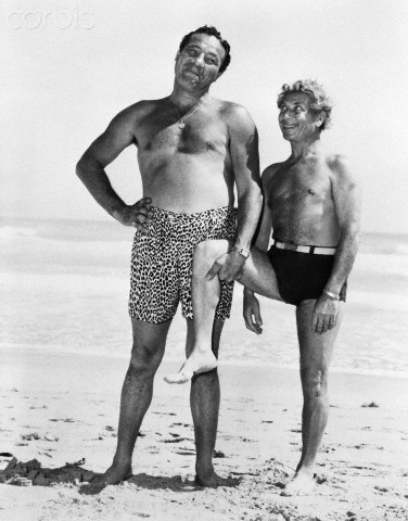 01 Mar 1946, Miami Beach, Florida, USA --- Original caption: 3/1/1946-Miami Beach, FLMaxie Baer plays stooge to Harpo Marx on the oceanfront at the Roney Plaza Hotel. It's one of Harpo's well known movie gestures--when he's not racing after blondes. --- Image by © Bettmann/CORBIS