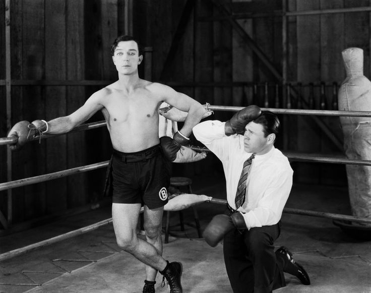 1926: American comedian Buster Keaton (1895-1966) in the boxing ring with a confused looking trainer in his latest film 'Battling Butler'.