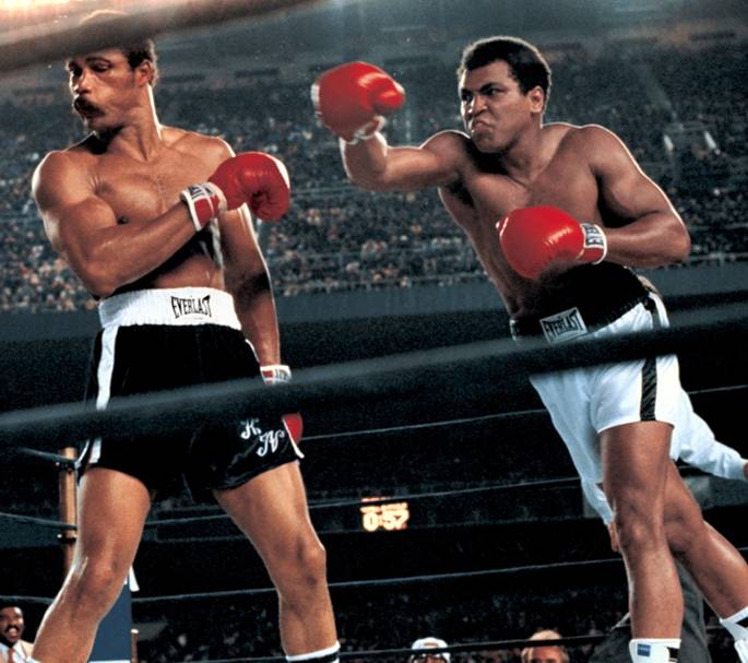 Muhammad Ali throwing a right hook to Ken Norton during the WBC/ WBA World Heavyweight Title fight at Yankee Stadium. The Bronx, New York 9/28/1976 (Image # 1177 )