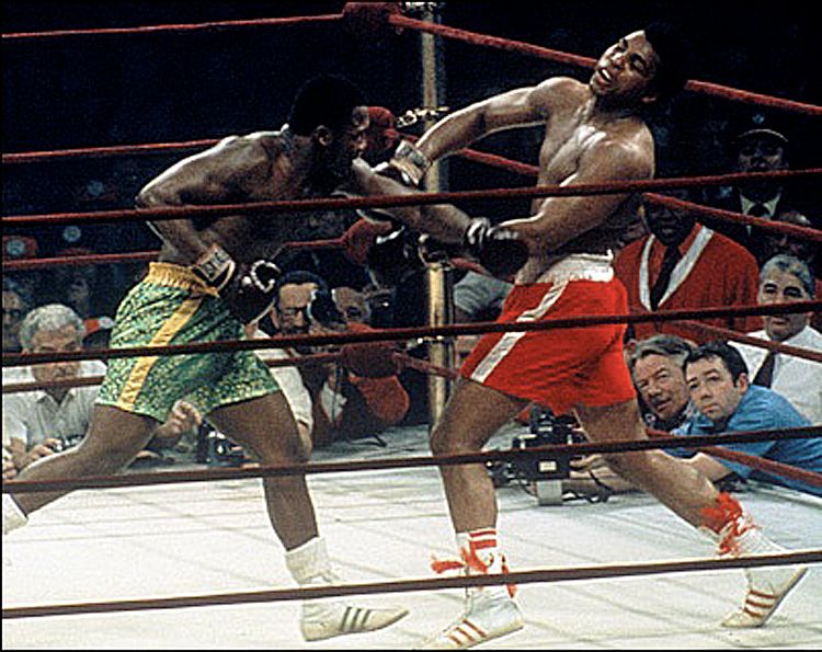 Joe Frazier landing a left hook to Muhammad Ali's chin in their iconic 1971 Heavyweight Championship Super Fight