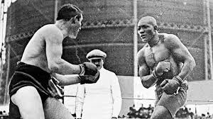 Johnson (R) winning the heavyweight title from champion Tommy Burns (L).