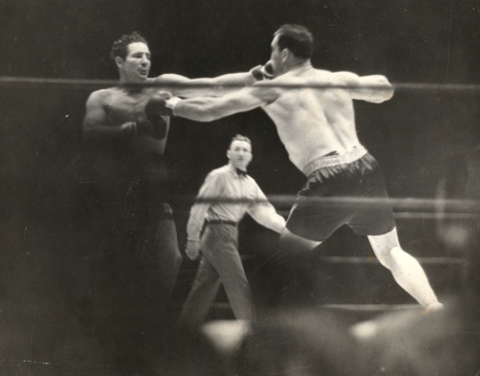 Primo Carnera and Max Baer trade hard jabs.