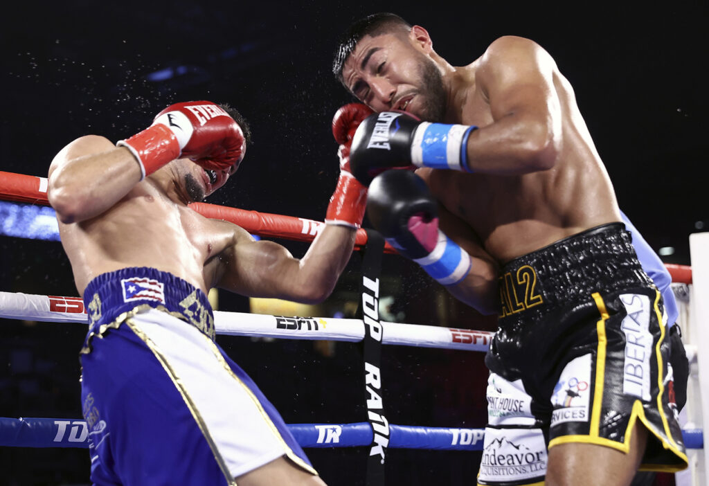 Orlando Gonzalez (L) lands a left hook to the jaw of Juan Antonio Lopez (R).