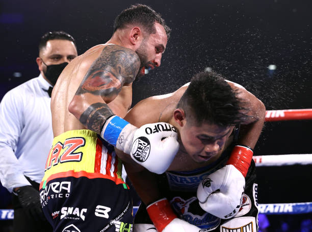  Emanuel Navarrete and Christopher Diaz exchange punches during their fight for the WBO featherweight title at the Silver Spurs Arena on April 24, 2021 in Kissimmee, Florida.