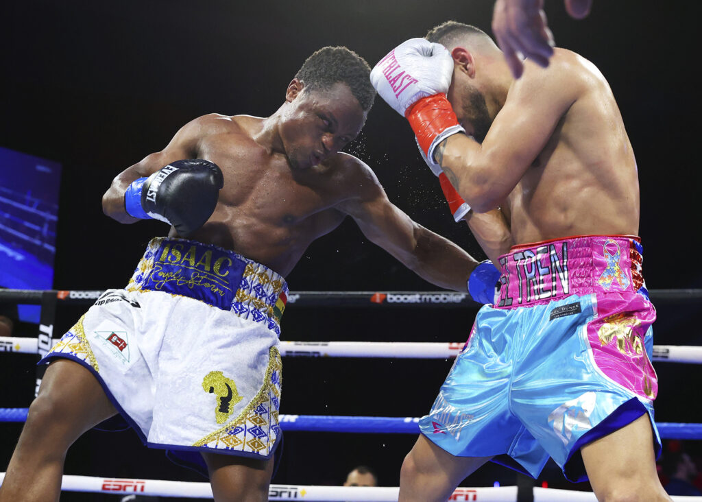 Isaac Dogboe (L) slams Robeisy Ramirez (R) with a hard right to the side.