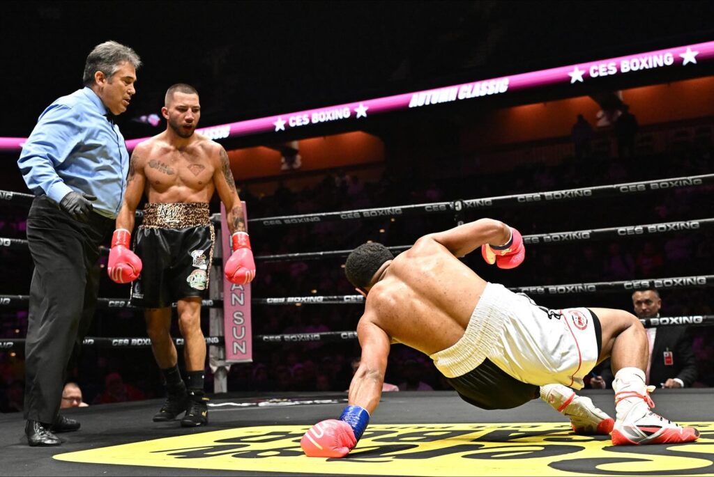 Kevin Walsh stands over Jose Nunez Sosa after dropping him in the 4th round. (Photo by CES)