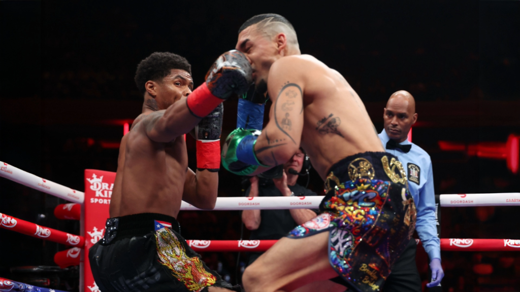 Stevenson (L) stabbing a jolting right right to the jaw of Lopez (R).