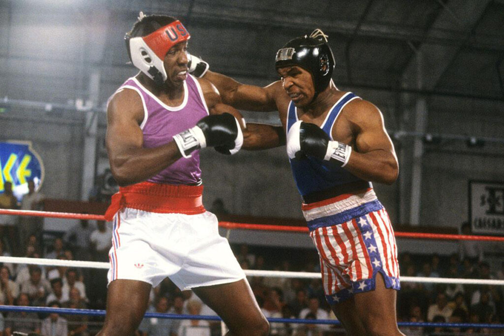 Mike Tyson(R) slamming a right cross to the jaw of Henry Tillman (L) in 1984.
